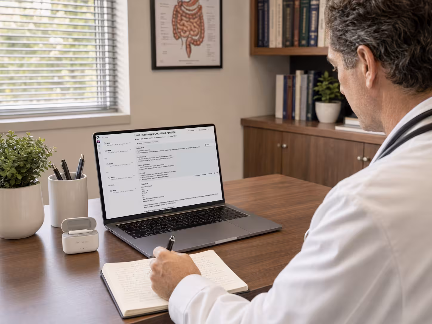 Clinician reviewing a CortexaNote note on a laptop with the recorder docked nearby