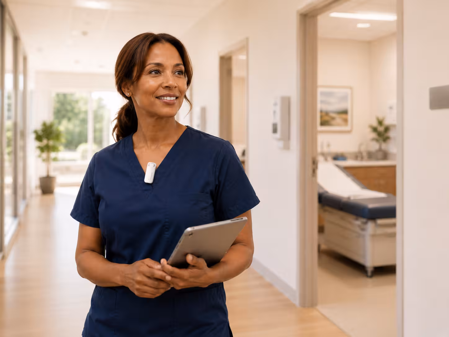 Nurse practitioner wearing the CortexaNote Recorder in a bright clinic hallway